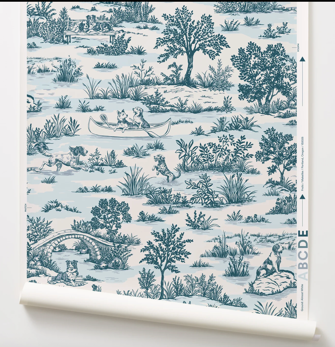 Roll of wallpaper with blue and white nature-themed design on a white background showing dogs playing.